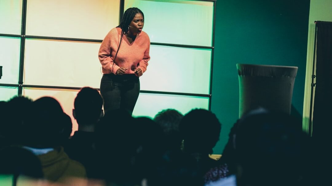 a woman standing on a stage in front of a crowd